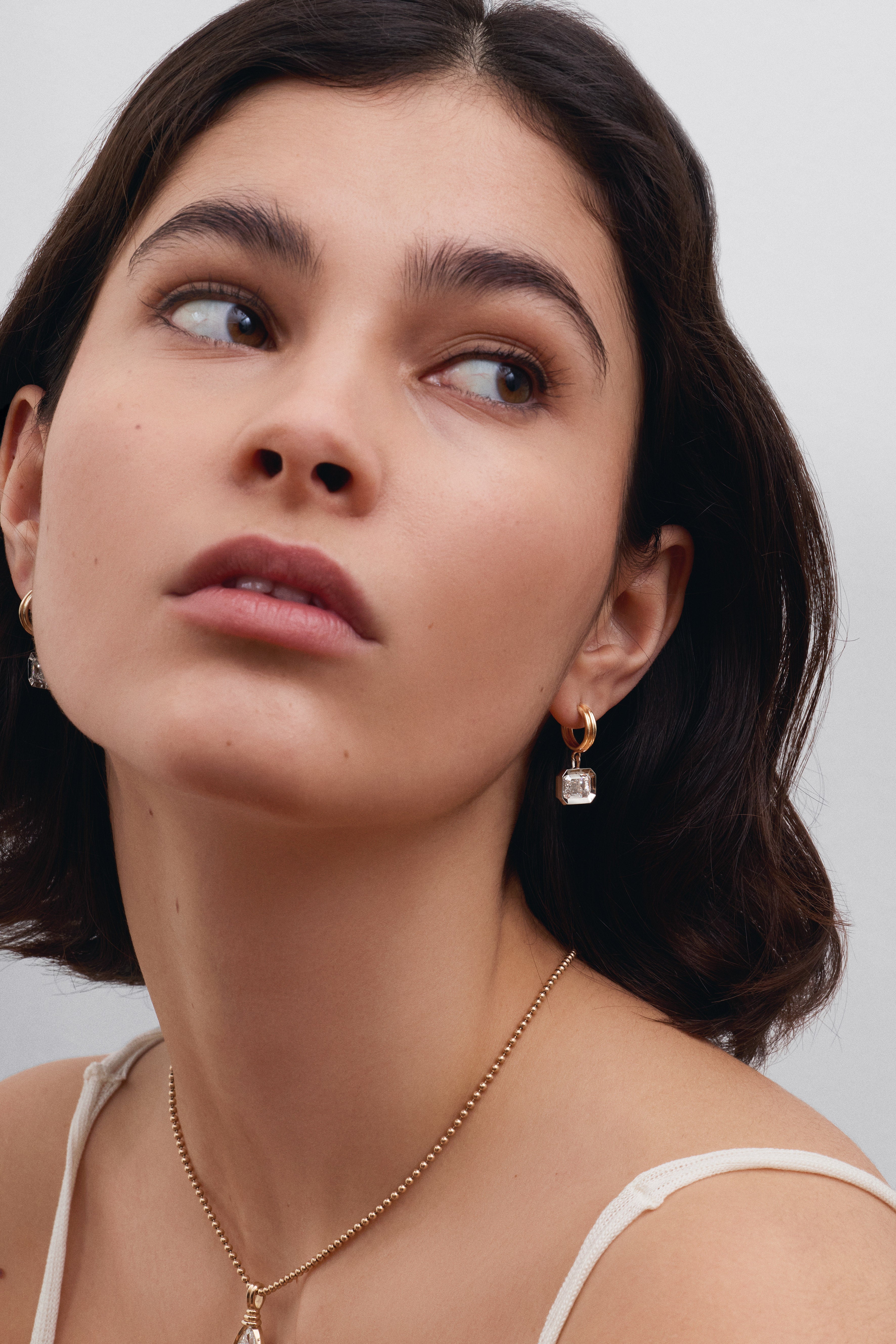 The Echo Earrings - Emerald Cut by East London jeweller Rachel Boston | Discover our collections of unique and timeless engagement rings, wedding rings, and modern fine jewellery.