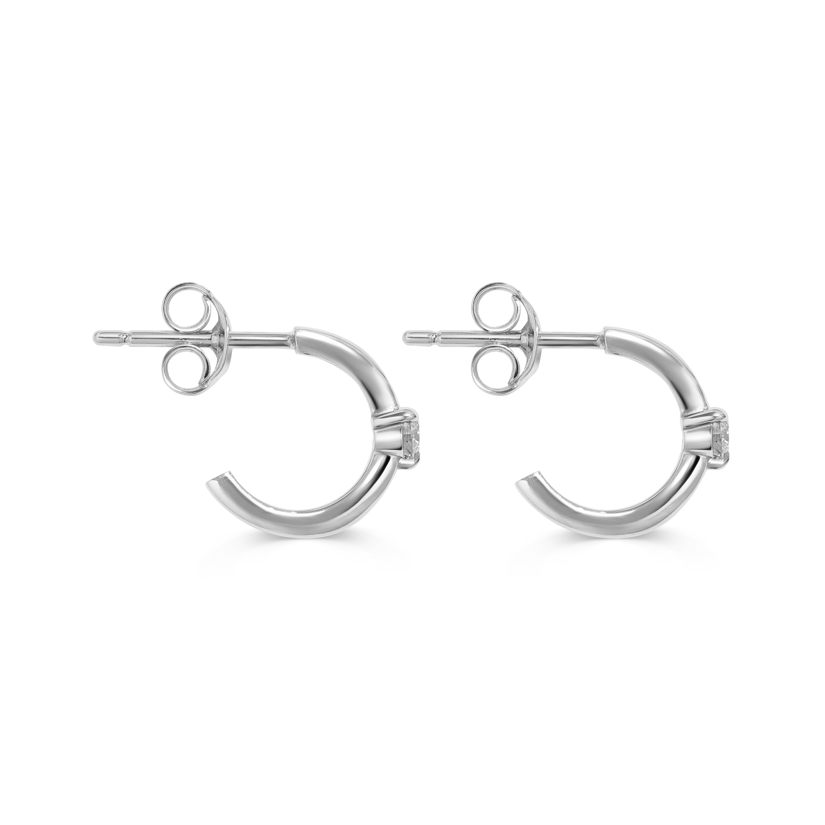 The Diamond Pinched Huggie Earrings by East London jeweller Rachel Boston | Discover our collections of unique and timeless engagement rings, wedding rings, and modern fine jewellery.