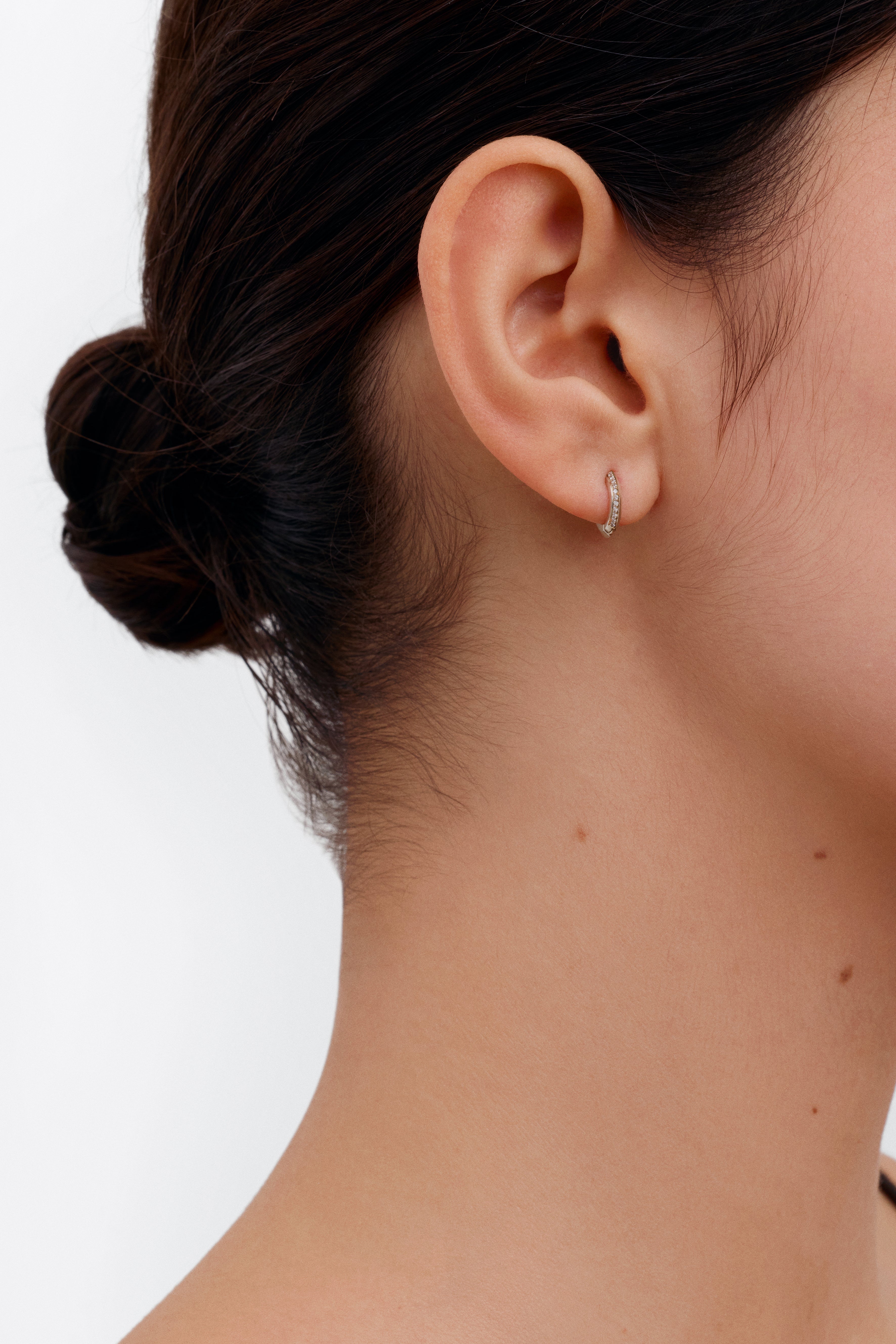 The 10mm Knife Edge Diamond Huggie Hoop Earrings by East London jeweller Rachel Boston | Discover our collections of unique and timeless engagement rings, wedding rings, and modern fine jewellery.