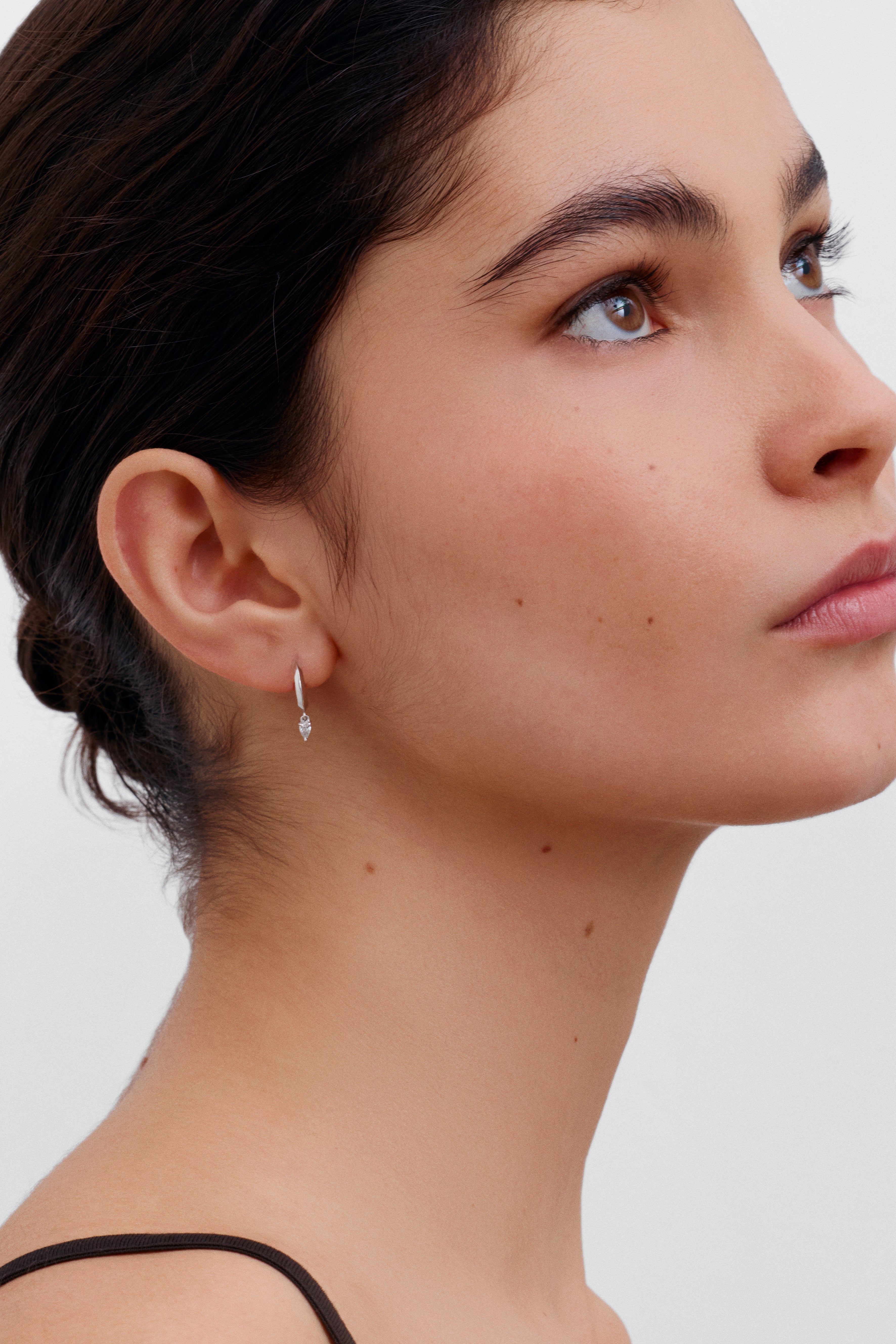 The Knife Edge Hoop Earrings with Pear Diamonds by East London jeweller Rachel Boston | Discover our collections of unique and timeless engagement rings, wedding rings, and modern fine jewellery.