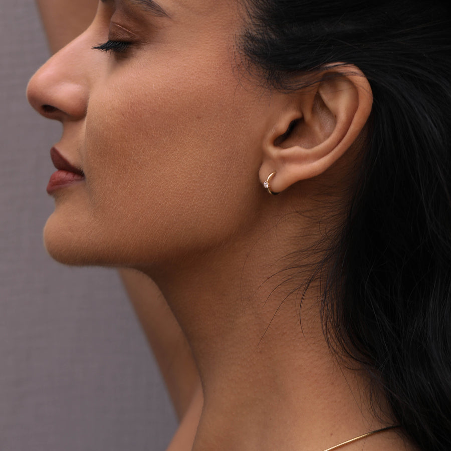 The Diamond Pinched Huggie Earrings by East London jeweller Rachel Boston | Discover our collections of unique and timeless engagement rings, wedding rings, and modern fine jewellery. - Rachel Boston Jewellery