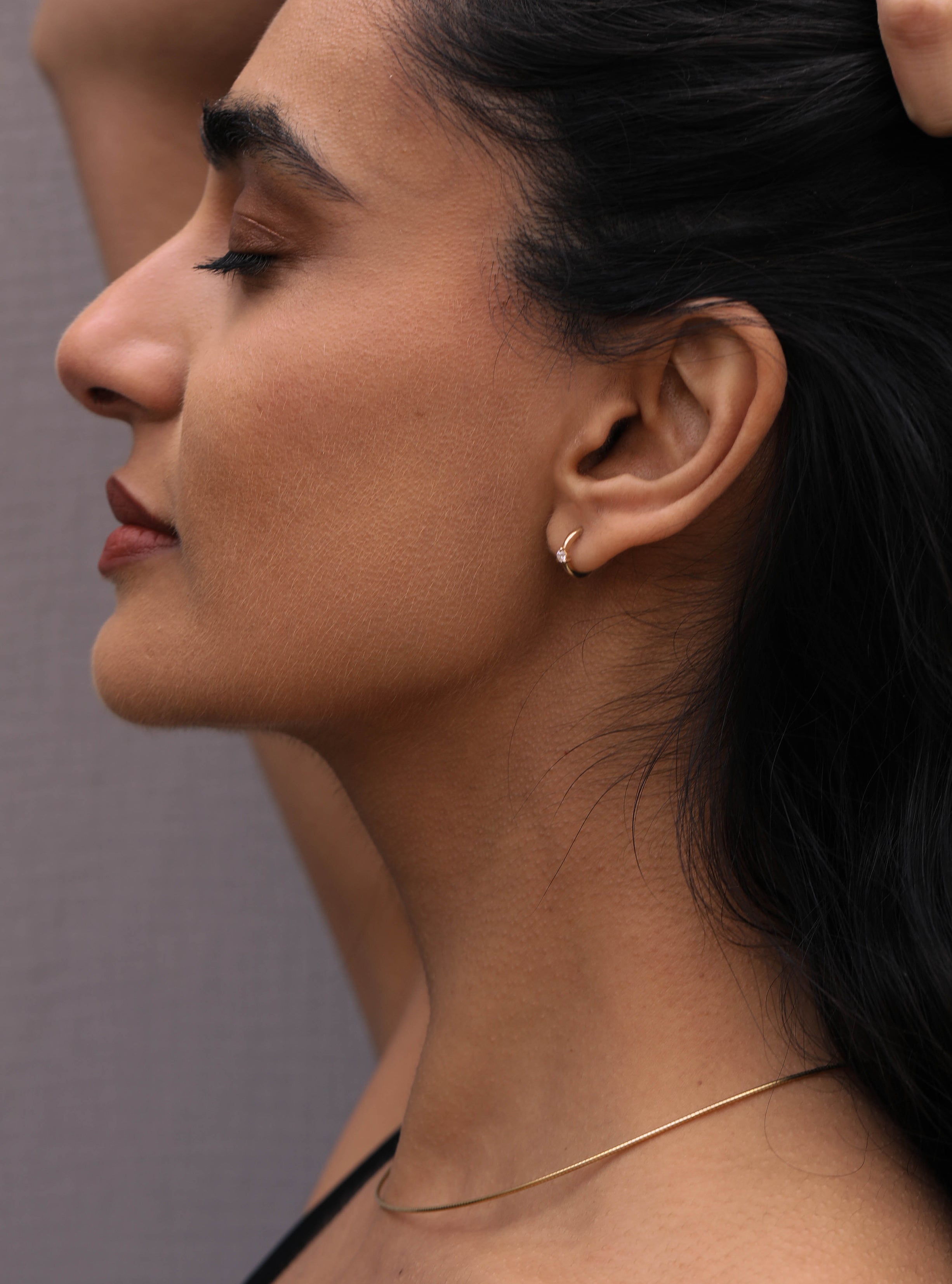 The Diamond Pinched Huggie Earrings by East London jeweller Rachel Boston | Discover our collections of unique and timeless engagement rings, wedding rings, and modern fine jewellery.