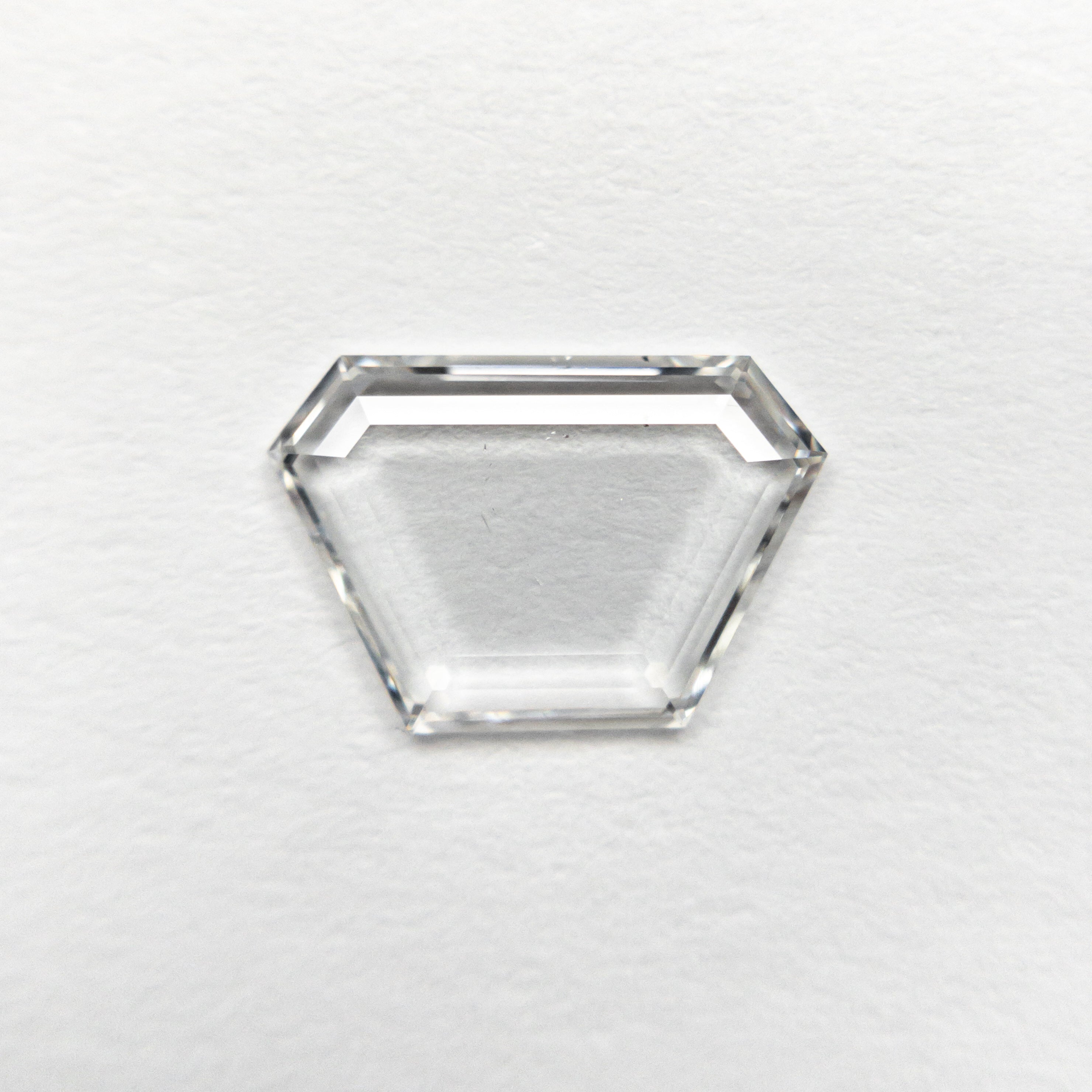 The 0.76ct 9.33x6.27x1.16mm SI2 F Trapezoid Portrait Cut 19854-26 by East London jeweller Rachel Boston | Discover our collections of unique and timeless engagement rings, wedding rings, and modern fine jewellery.