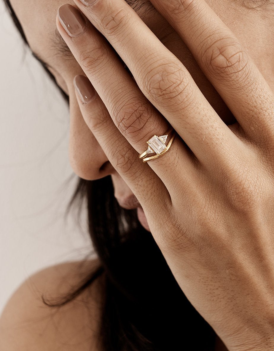 The Crux Ring - Emerald Cut by East London jeweller Rachel Boston | Discover our collections of unique and timeless engagement rings, wedding rings, and modern fine jewellery.